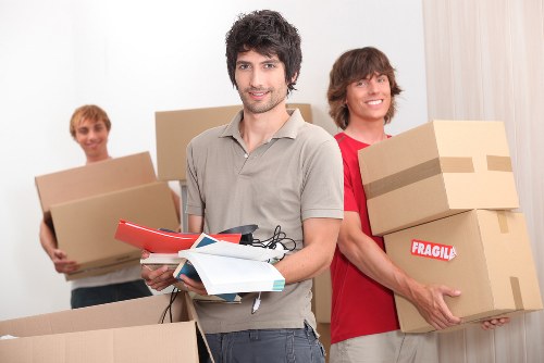 Professional movers loading household items for an East London relocation